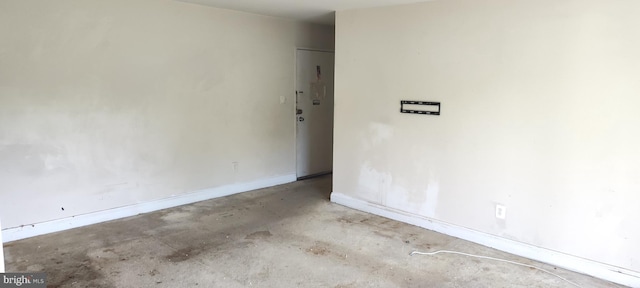 unfurnished room featuring concrete flooring