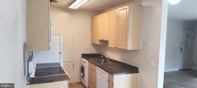 kitchen featuring washer / dryer, white dishwasher, range, and sink