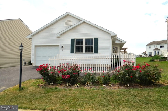 view of front of property featuring a garage and a front lawn