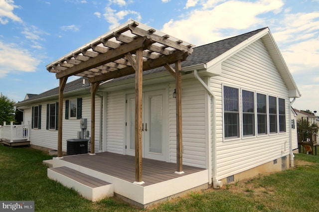 back of property featuring a pergola, a wooden deck, a lawn, and central AC unit