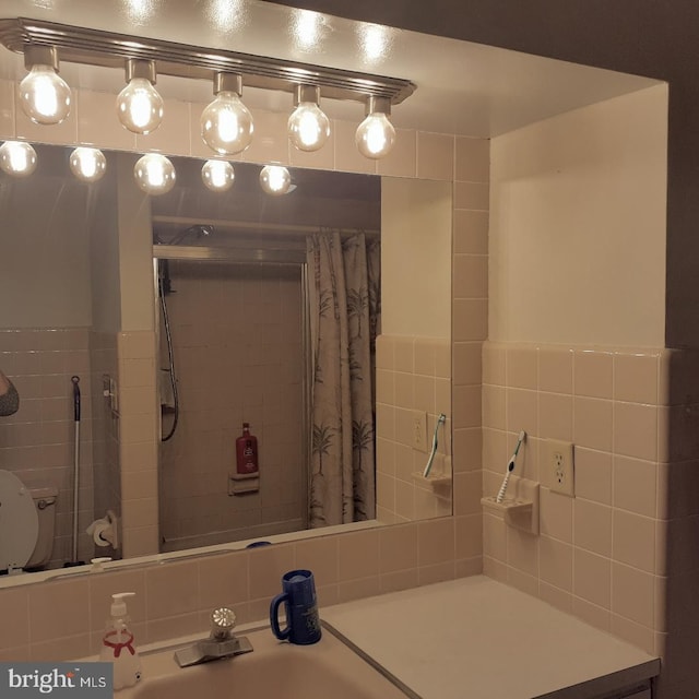 bathroom with curtained shower and sink