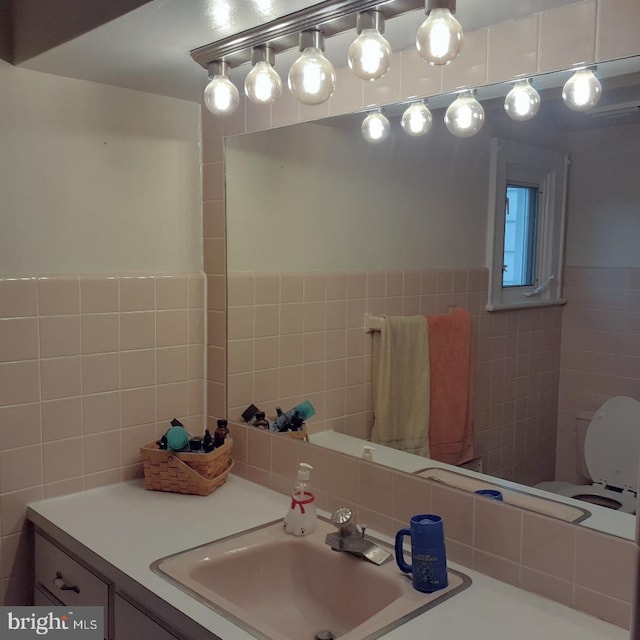 bathroom with tile walls and vanity