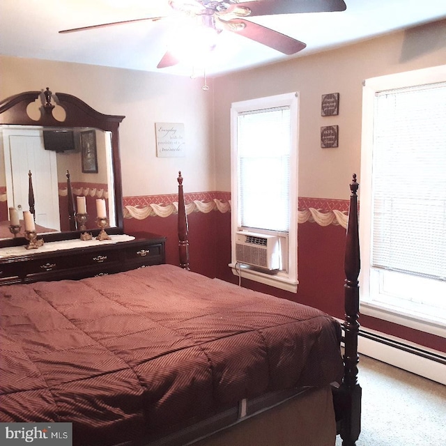 carpeted bedroom with a baseboard heating unit, cooling unit, and ceiling fan