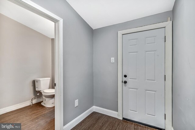 entryway with dark hardwood / wood-style flooring