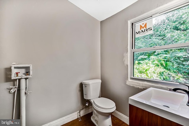 bathroom with hardwood / wood-style flooring, vanity, and toilet