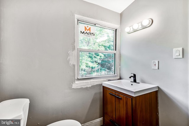 bathroom featuring vanity and toilet