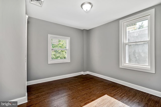 spare room with dark hardwood / wood-style flooring