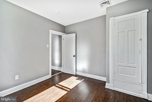 unfurnished bedroom featuring dark wood-type flooring