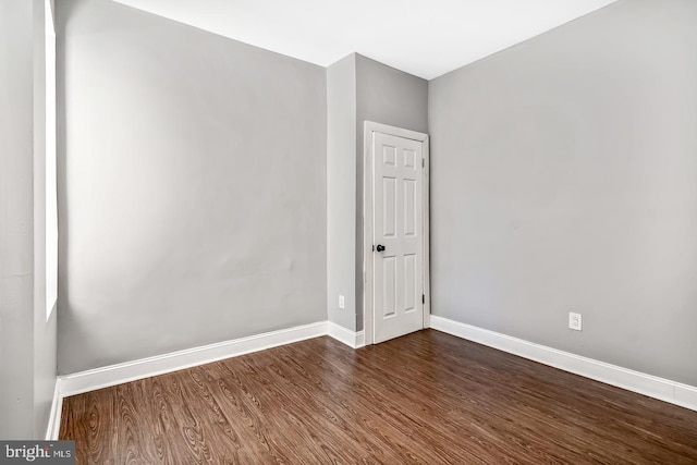 unfurnished room featuring dark wood-type flooring