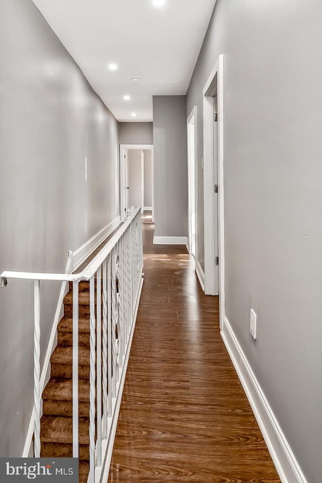 corridor with dark hardwood / wood-style floors