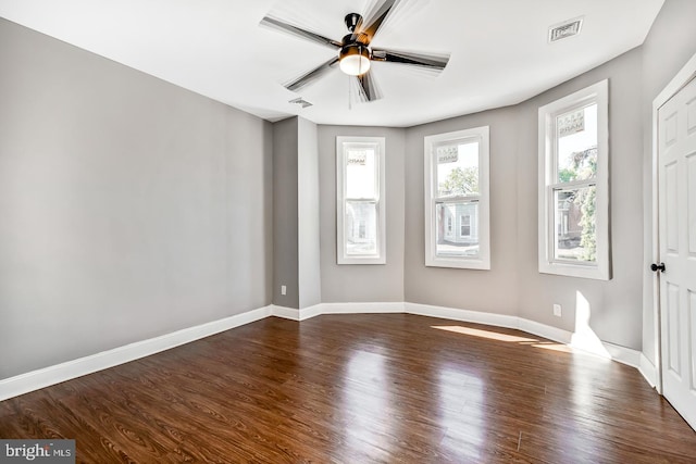 spare room featuring ceiling fan and dark wood-type flooring