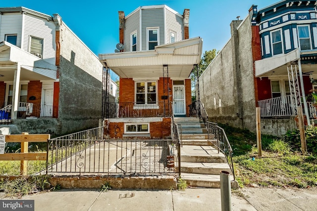 view of front of property with covered porch and brick siding