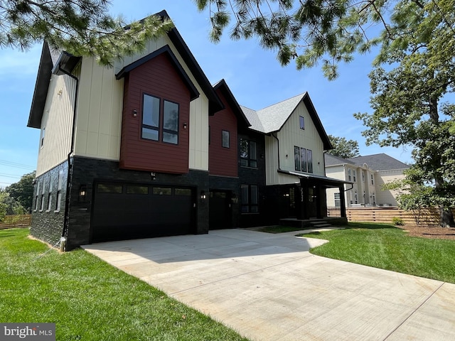 view of front of home featuring a front yard and a garage