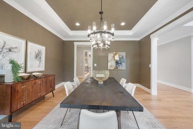 dining room with recessed lighting, a raised ceiling, light wood-style floors, ornamental molding, and baseboards