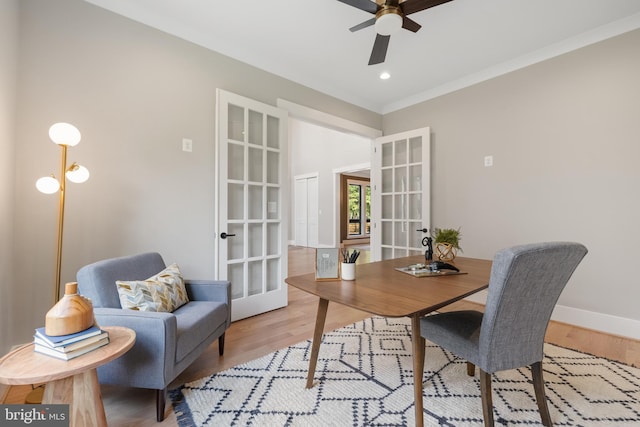 dining room with french doors, crown molding, light hardwood / wood-style floors, and ceiling fan