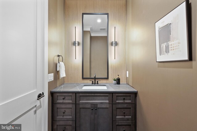 bathroom with ornamental molding and vanity