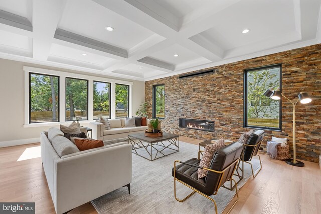 living room with beamed ceiling, light hardwood / wood-style floors, and coffered ceiling