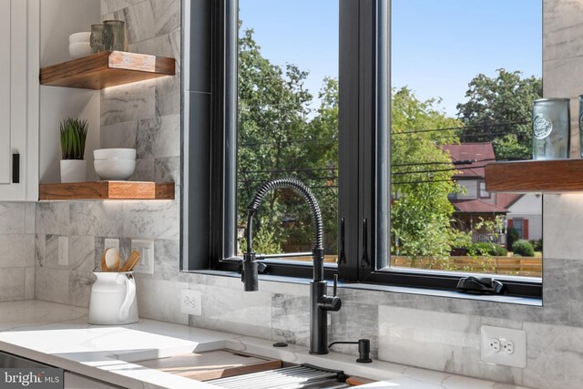 details with light stone countertops and sink