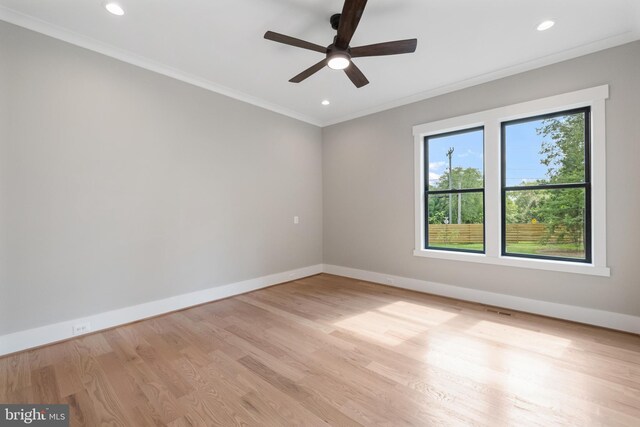 empty room featuring ornamental molding, light hardwood / wood-style floors, and ceiling fan