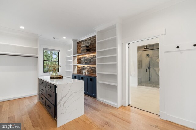 spacious closet with light hardwood / wood-style floors