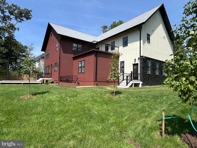 rear view of house with a lawn