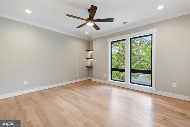 spare room with ceiling fan, ornamental molding, and light hardwood / wood-style floors