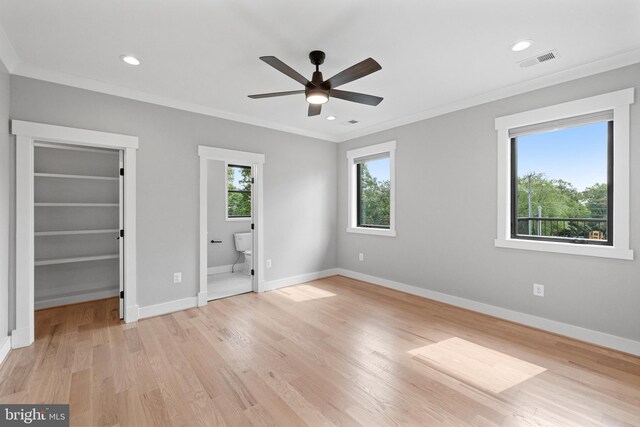 unfurnished bedroom with connected bathroom, crown molding, light hardwood / wood-style floors, and ceiling fan