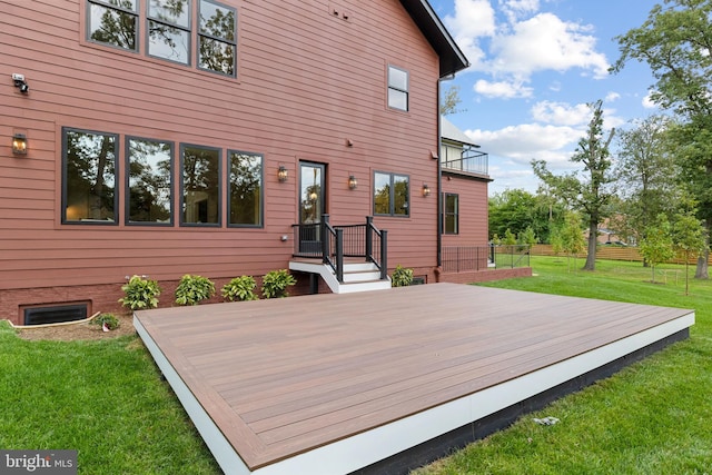 wooden deck featuring a lawn