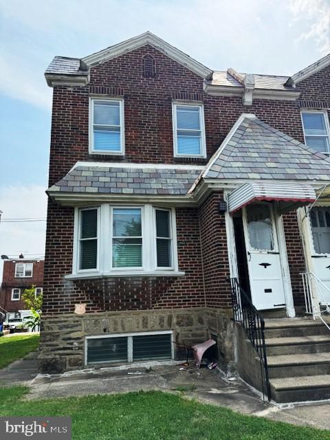 multi unit property featuring brick siding and a high end roof