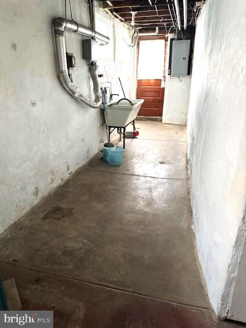 basement featuring electric panel and sink