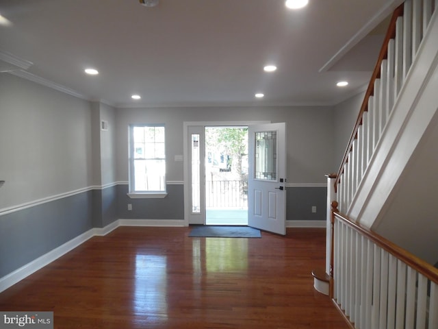 entryway featuring crown molding and dark wood-type flooring