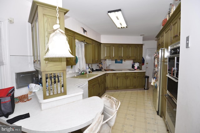 kitchen featuring dishwasher, oven, and sink