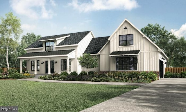 modern farmhouse style home featuring board and batten siding, a front yard, a standing seam roof, and metal roof