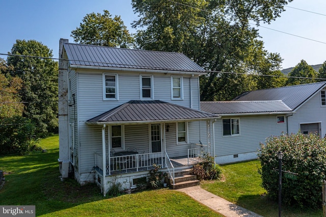 view of front facade featuring a front lawn, a standing seam roof, a porch, metal roof, and crawl space