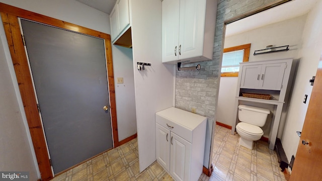 bathroom featuring tile patterned floors, toilet, and baseboards