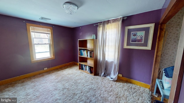 spare room featuring visible vents, baseboards, and carpet flooring