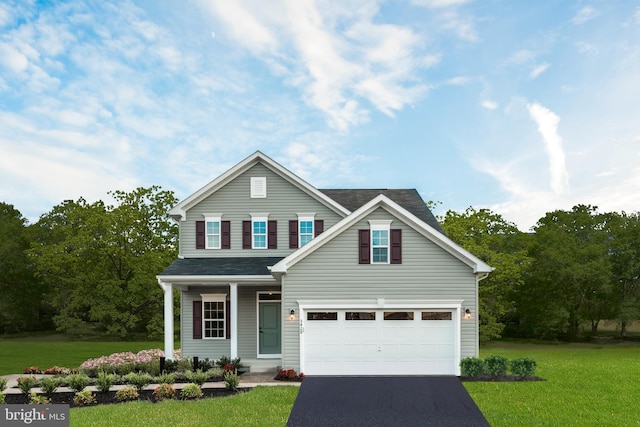 view of front of home featuring a front lawn, a porch, and a garage