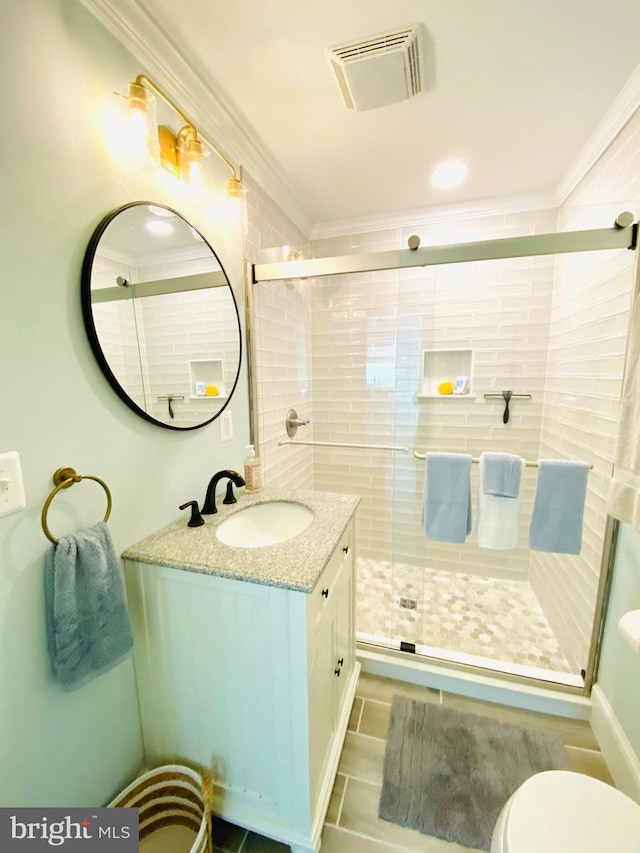 bathroom with vanity, toilet, walk in shower, and crown molding