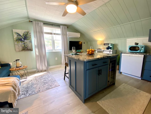 kitchen with a center island, white dishwasher, an AC wall unit, vaulted ceiling, and light wood-type flooring