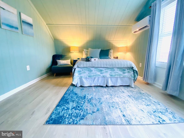 bedroom featuring a wall mounted air conditioner, wood ceiling, and hardwood / wood-style flooring