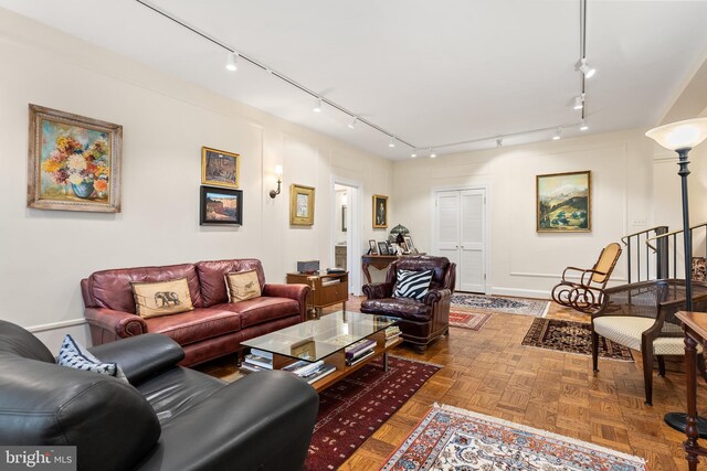 living room with rail lighting and parquet flooring