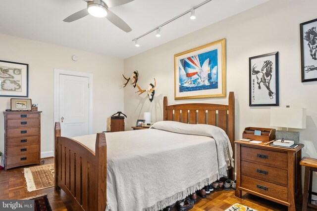 bedroom featuring track lighting and ceiling fan