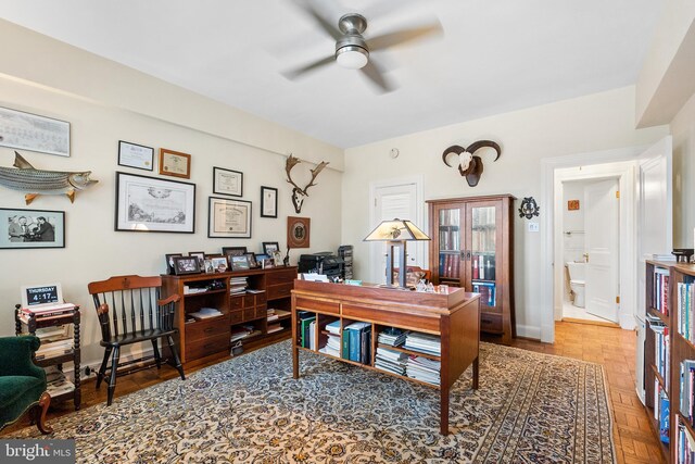 office area with ceiling fan and parquet flooring