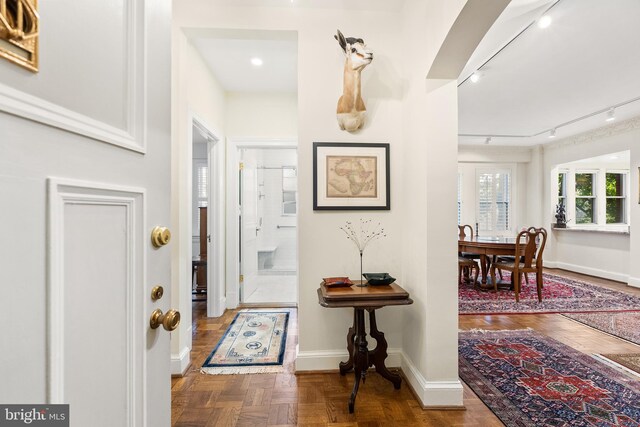 entrance foyer with track lighting and parquet flooring