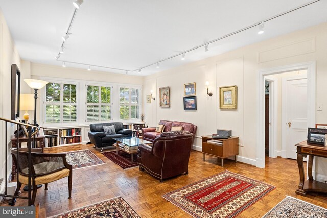 living room featuring track lighting and parquet floors