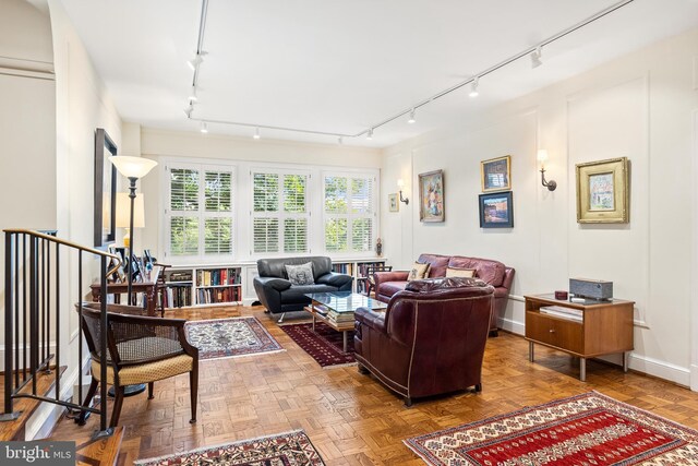 living room with rail lighting and parquet floors