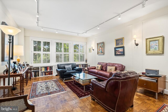 living room featuring parquet flooring and track lighting