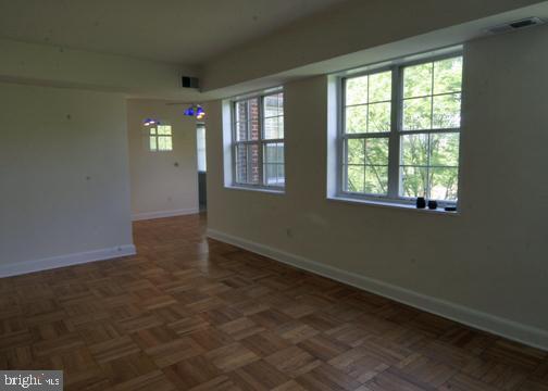 unfurnished room with visible vents and baseboards