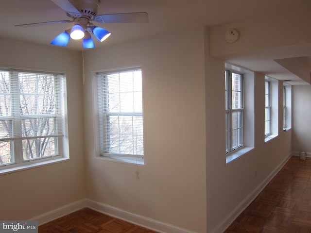 interior space featuring ceiling fan and baseboards