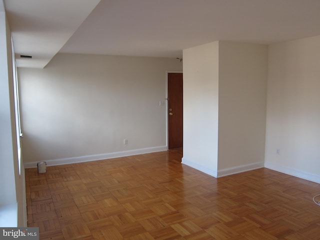 unfurnished room featuring baseboards